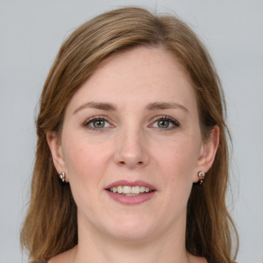 Joyful white young-adult female with long  brown hair and green eyes
