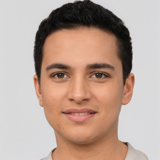 Joyful latino young-adult male with short  brown hair and brown eyes