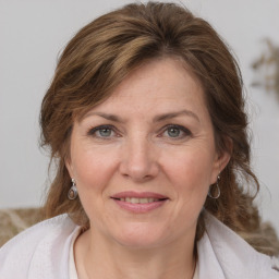 Joyful white adult female with medium  brown hair and grey eyes