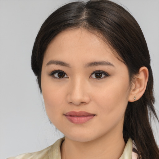 Joyful latino young-adult female with medium  brown hair and brown eyes