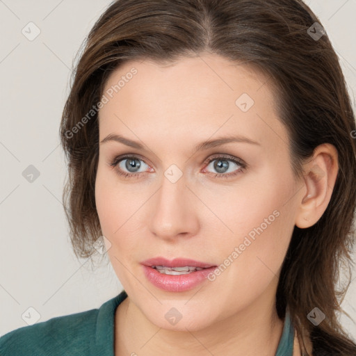 Joyful white young-adult female with medium  brown hair and blue eyes