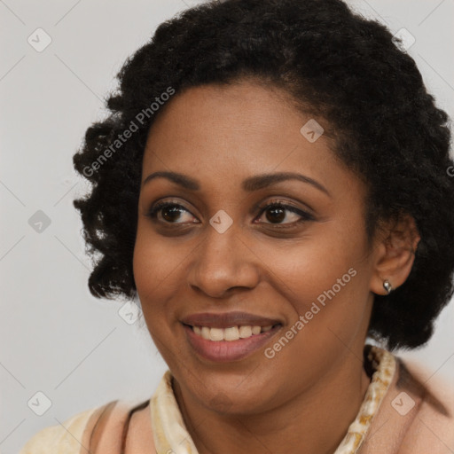 Joyful black young-adult female with long  black hair and brown eyes