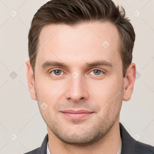 Joyful white young-adult male with short  brown hair and grey eyes