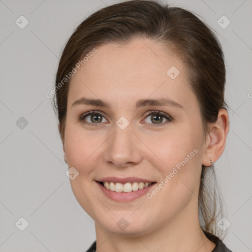 Joyful white young-adult female with medium  brown hair and grey eyes