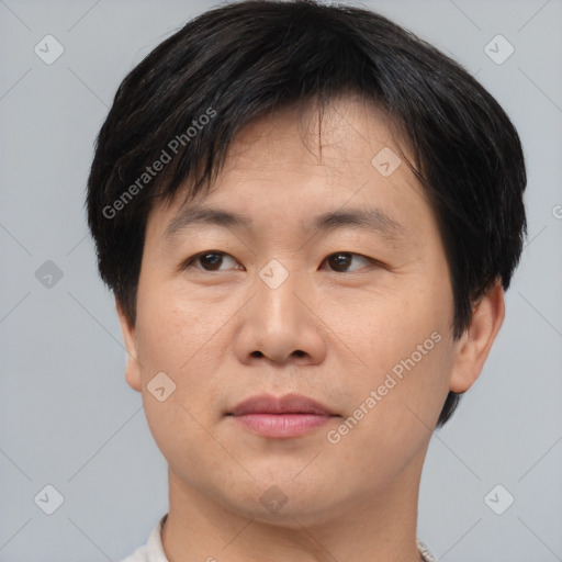 Joyful asian young-adult male with short  brown hair and brown eyes