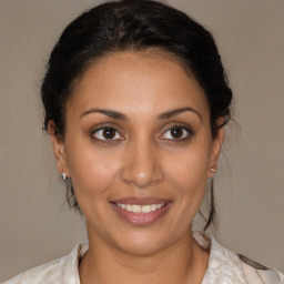 Joyful latino young-adult female with medium  brown hair and brown eyes