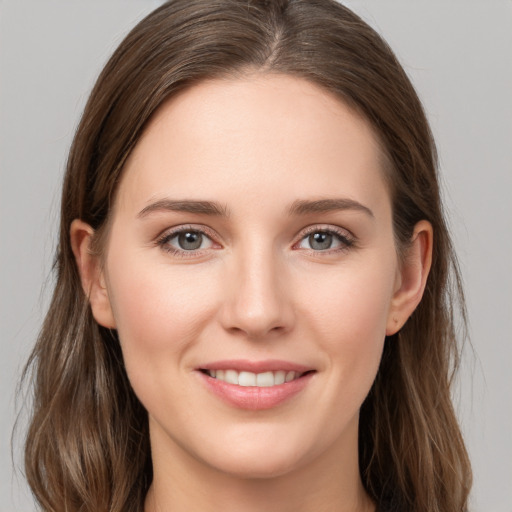 Joyful white young-adult female with long  brown hair and grey eyes