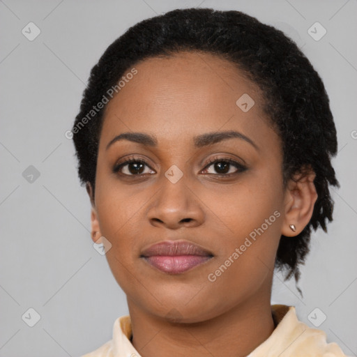 Joyful black young-adult female with short  black hair and brown eyes