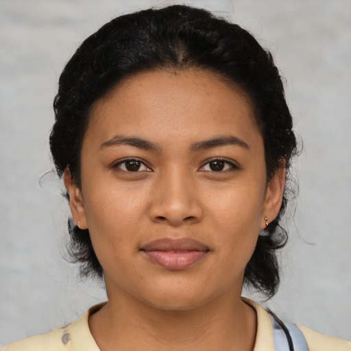Joyful latino young-adult female with medium  black hair and brown eyes