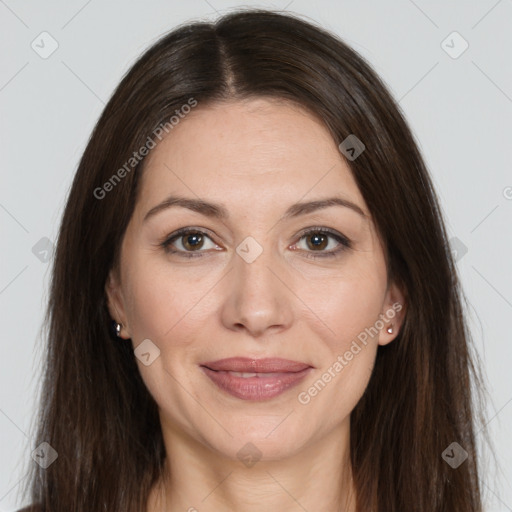 Joyful white adult female with long  brown hair and brown eyes