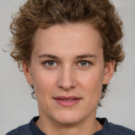 Joyful white young-adult female with medium  brown hair and blue eyes