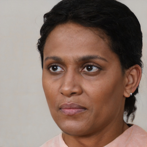Joyful latino adult female with short  black hair and brown eyes