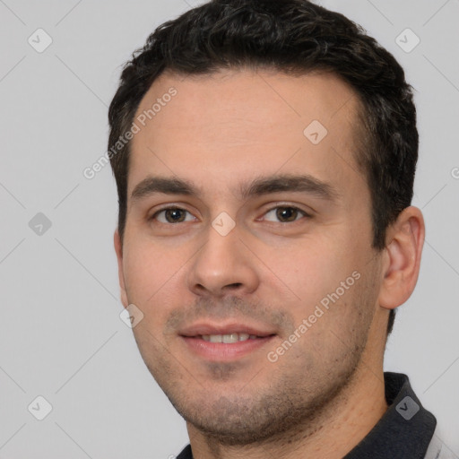 Joyful white young-adult male with short  black hair and brown eyes