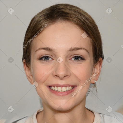 Joyful white young-adult female with medium  brown hair and blue eyes