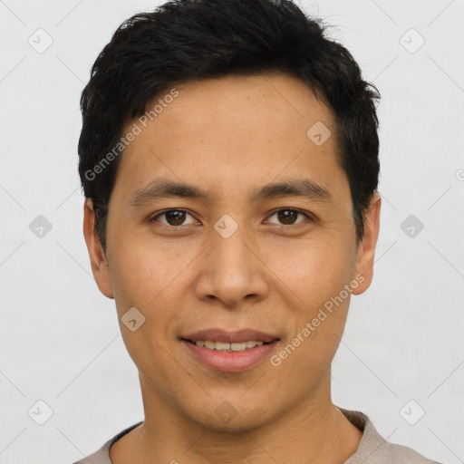 Joyful asian young-adult male with short  black hair and brown eyes