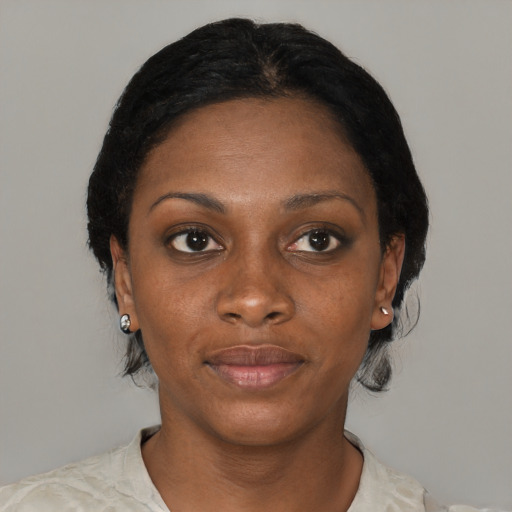 Joyful black young-adult female with short  black hair and brown eyes
