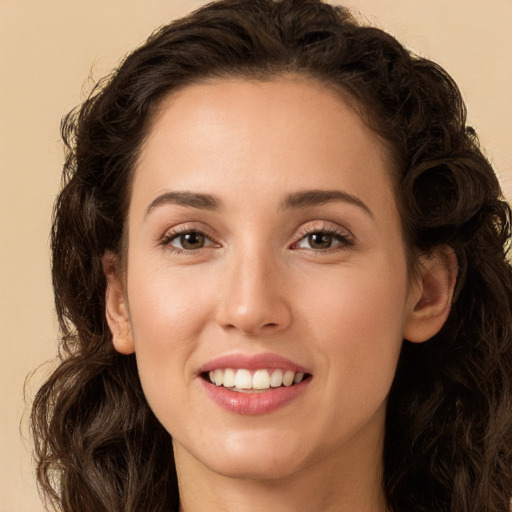 Joyful white young-adult female with long  brown hair and brown eyes