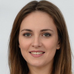 Joyful white young-adult female with long  brown hair and green eyes