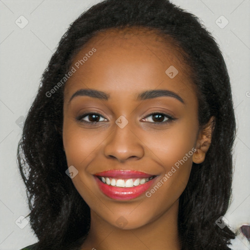 Joyful black young-adult female with long  black hair and brown eyes