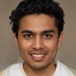 Joyful latino young-adult male with short  brown hair and brown eyes