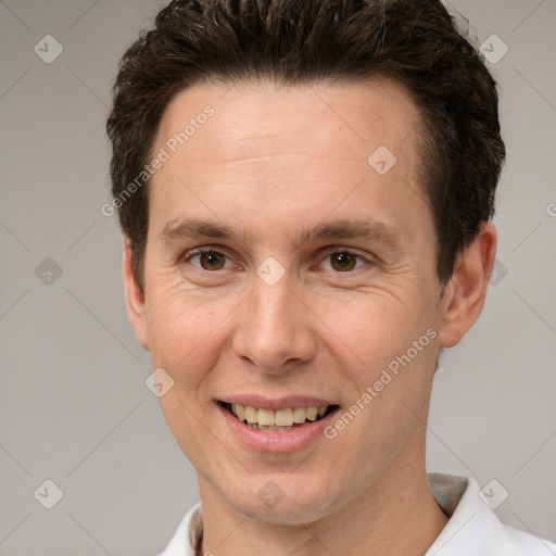 Joyful white adult male with short  brown hair and brown eyes