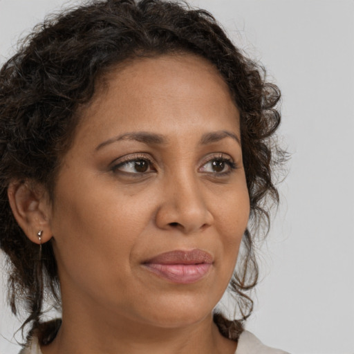 Joyful black adult female with medium  brown hair and brown eyes
