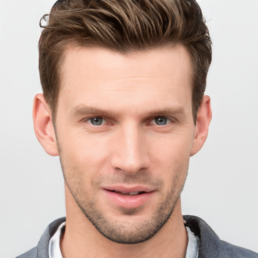 Joyful white young-adult male with short  brown hair and grey eyes