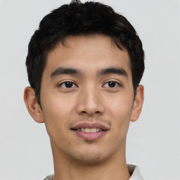 Joyful asian young-adult male with short  black hair and brown eyes