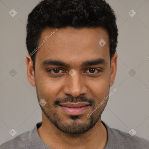 Joyful black young-adult male with short  black hair and brown eyes