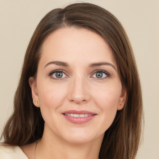 Joyful white young-adult female with long  brown hair and green eyes