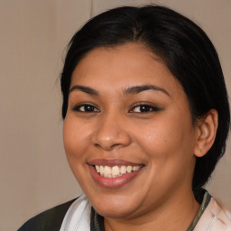 Joyful latino young-adult female with medium  brown hair and brown eyes