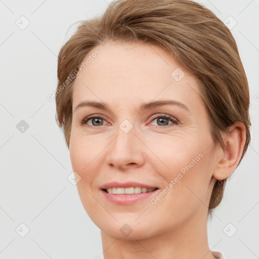 Joyful white adult female with short  brown hair and grey eyes