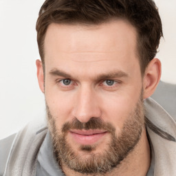 Joyful white adult male with short  brown hair and grey eyes