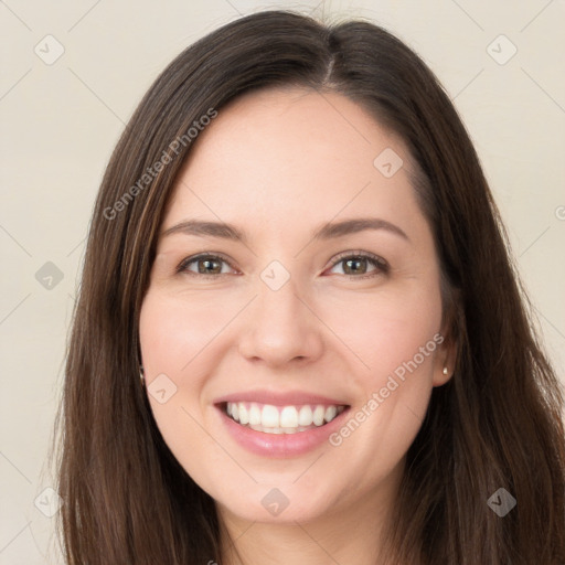 Joyful white young-adult female with long  brown hair and green eyes