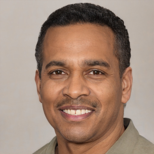 Joyful latino adult male with short  black hair and brown eyes