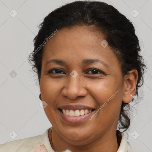 Joyful latino young-adult female with short  brown hair and brown eyes