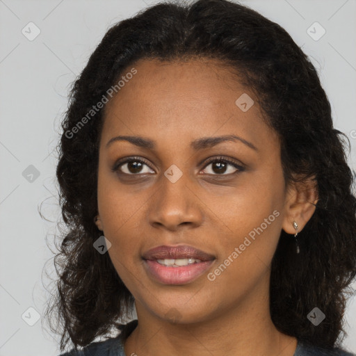 Joyful black young-adult female with long  brown hair and brown eyes