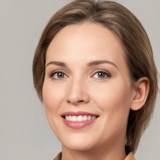 Joyful white young-adult female with medium  brown hair and grey eyes