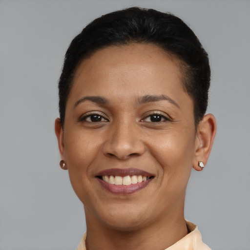 Joyful latino young-adult female with short  black hair and brown eyes