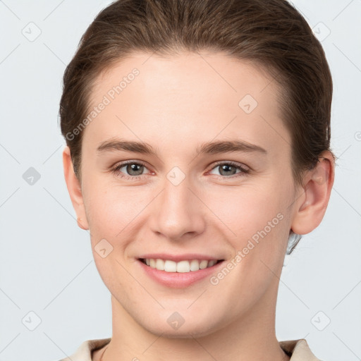 Joyful white young-adult female with short  brown hair and grey eyes