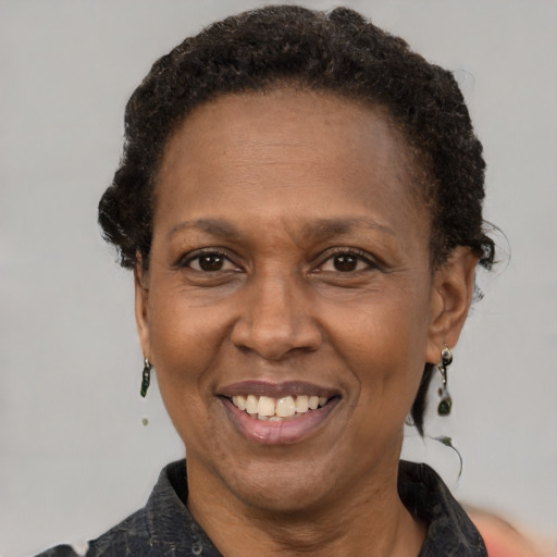 Joyful black adult female with short  brown hair and brown eyes