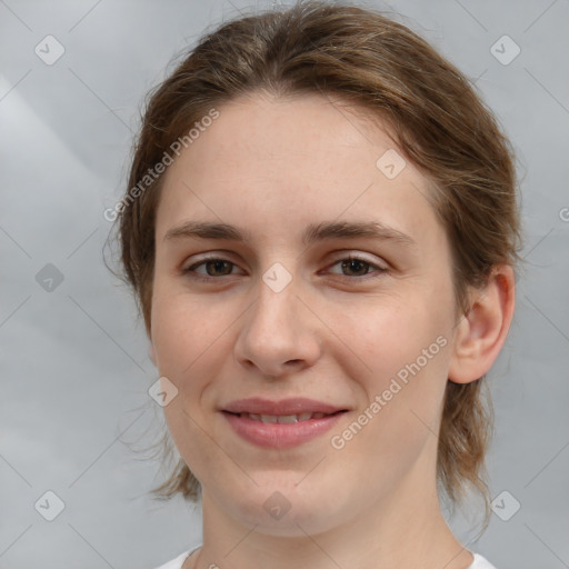 Joyful white young-adult female with medium  brown hair and grey eyes