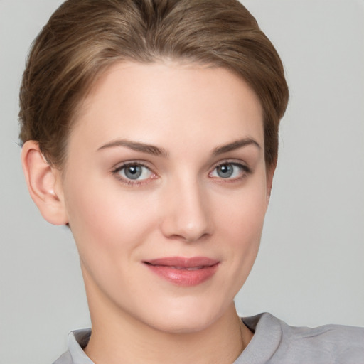 Joyful white young-adult female with short  brown hair and grey eyes