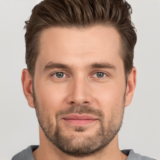 Joyful white young-adult male with short  brown hair and brown eyes