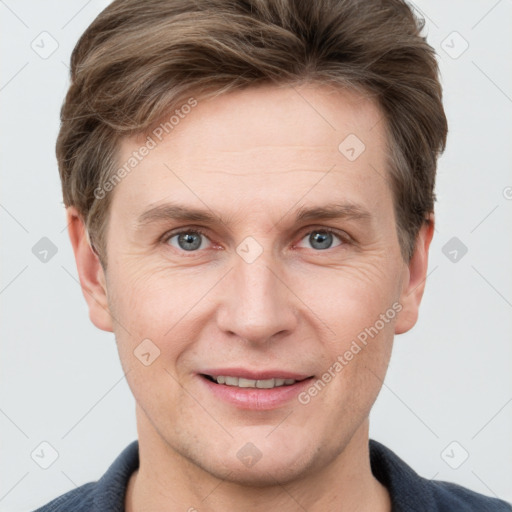 Joyful white adult male with short  brown hair and grey eyes