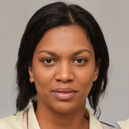 Joyful black young-adult female with medium  brown hair and brown eyes