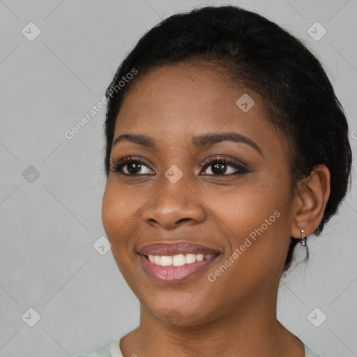 Joyful black young-adult female with short  brown hair and brown eyes