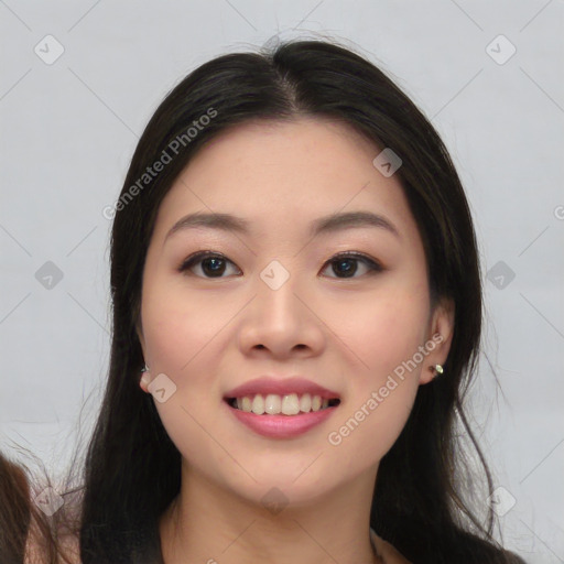 Joyful asian young-adult female with long  black hair and brown eyes