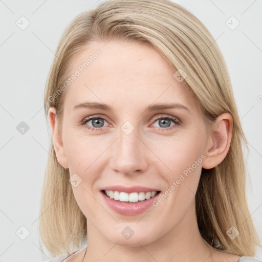 Joyful white young-adult female with long  brown hair and blue eyes