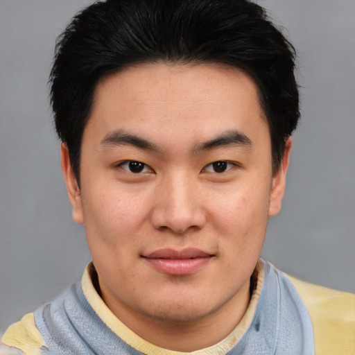 Joyful asian young-adult male with short  black hair and brown eyes